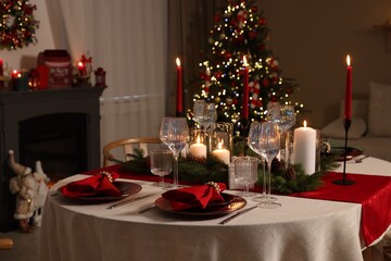Festive table setting with Christmas decor indoors