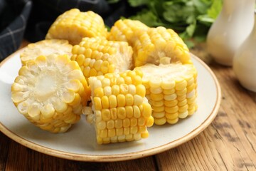Pieces of boiled corn cobs on wooden table, closeup