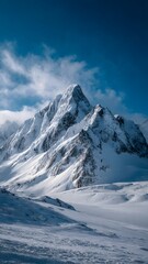 Majestic snow covered mountain peaks under a vivid blue sky