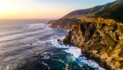 Fototapeta premium Ocean waves crash against rocky cliffs under a golden sunset, highlighting mountainous landscape silhouette