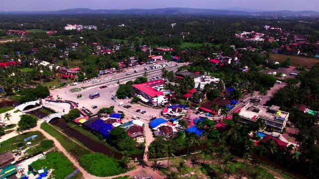 Aerial view of colva with beach, creek, parking area, greenery and shoreline at goa, india. day time, circle shot, drone shot, 4k.