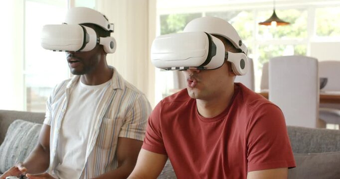 Diverse male friends in VR headsets adjusting controllers playing game smiling on sofa