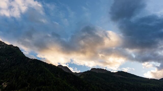 Fast-moving clouds linger above the serene Alps, a breathtaking view