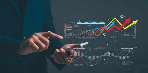 A business professional analyzes data on a smartphone, showcasing various graphs and trends on a digital display.