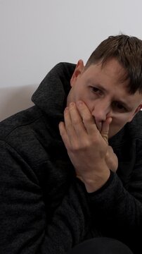 Vertical: white caucasian man having a panic attack at home, static shot, medium shot