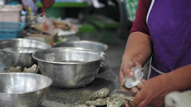 Crack open the oyster shells and place them on a plate.