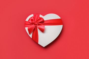 Valentines days heart shaped red gift box heart isolated on red background. Greeting card.