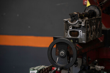 Car engine cylinder head on repair machine in workshop