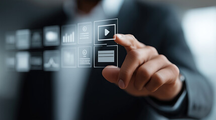 Professional hand interacts with futuristic digital interface selecting multimedia content icons strategically.
