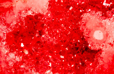 Amethyst red crystals. Gems. Mineral crystals in the natural environment. Texture of precious and semiprecious stones. Seamless background with copy space colored shiny surface of precious stones.