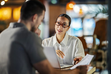 Business colleagues collaborating on project, sharing ideas in office