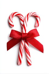 two cane candy striped peppermint canes tied with red satin bow on white background, Christmas holiday confection flat lay image