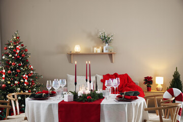 Festive table setting with Christmas decor indoors