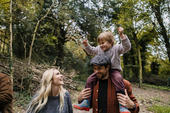Happy family enjoying hiking together in park