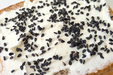 Fresh Breakfast Concept: Creamy Cheese Spread on Bread with Black Sesame Seeds