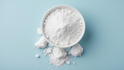 White ceramic bowl with baking soda spilling onto pastel surface, evoking natural cleaning, diy laundry solutions and gentle zero waste lifestyle choices