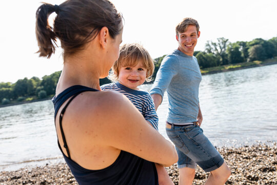 Happy family enjoying time together outdoors by the river