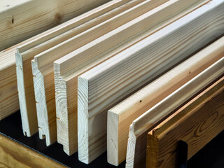 Wood pieces stacked and organized on a workbench in a carpentry shop during daytime hours