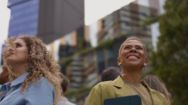 Diverse crowd of hopeful people looking up in awe