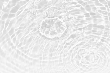 White water with ripples on the surface. Defocus blurred transparent white colored clear calm water surface texture with splashes and bubbles. Water waves with shining pattern texture background.
