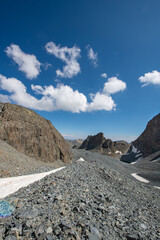 Blue clouds and snow-capped mountains. The Kaçkar Mountains covered in snow. Hiking in the snowy mountains. Walking towards the snowy mountains. Kaçkar Summit. Artvin, Türkiye.
