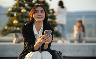 Confident Asian businesswoman smiling in a modern corporate setting, attractive professional lady standing outdoors, showcasing success, beauty, career ambition, and cheerful lifestyle.