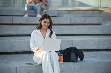 Confident Asian businesswoman smiling in a modern corporate setting, attractive professional lady standing outdoors, showcasing success, beauty, career ambition, and cheerful lifestyle.