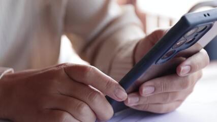 Hands using a smartphone in a workspace, close-up, representing digital communication, modern technology, and mobile productivity - Powered by Adobe