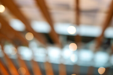 A warm and soft bokeh background captured inside a modern cafe, featuring blurred lights and abstract shapes. Perfect for banners, lifestyle promotions, or templates cozy and atmospheric backdrop