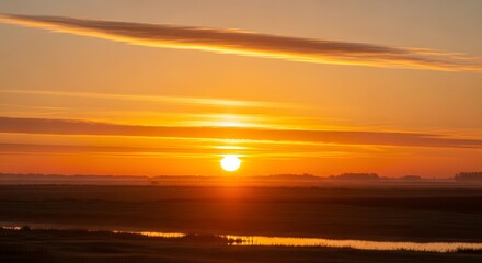 Naklejka premium Golden dawn sun dramatic fiery sky rural field water reflection