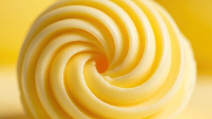 Close up spiral swirl of yellow food product with soft texture
