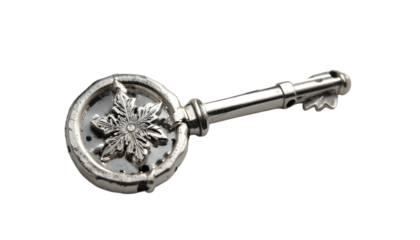 Antique silver skeleton key featuring an ornate snowflake design on the bow on a stark for magic