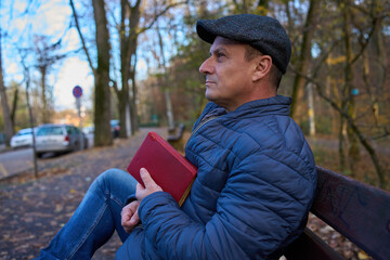 Fototapeta premium Man in thoughtful moment with book