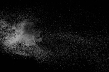 The falling white snow on a black background