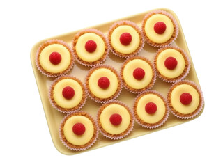 Isolated tray of mini cheesecakes topped with fresh raspberries, delicious dessert sweets