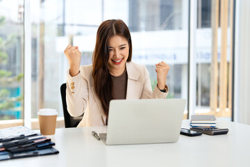 Businessman, winner and success fist in office for celebration, promotion and achievement of goal. Male person or salesman and deal or target with smile, hands up and computer with good news