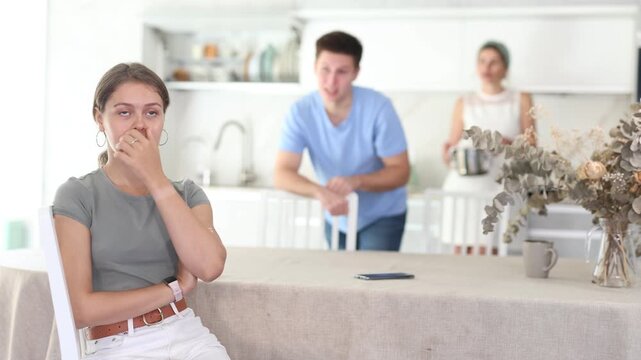 Woman mother and young guy during family quarrel accuse adult daughter Woman and young guy swear at girl. Mom and older brother scold young girl for unsuccessful studies at university. Complex
