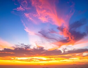Fototapeta premium Fiery sunset with swirling pink and orange clouds against a blue sky gradient