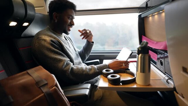 Young businessman working on a tablet during train journey