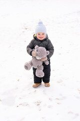 Happy little boy playing outdoor in winter season