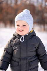 Happy little boy playing outdoor in winter season