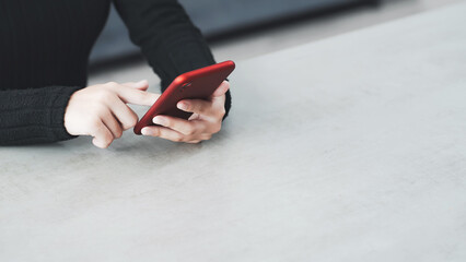 A woman using a smartphone in her room
