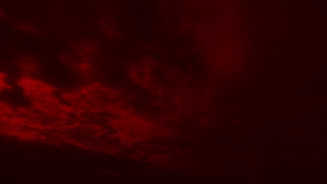 Wide shot of red storm clouds moving rapidly across dark sky. Dramatic background for horror, thriller, or sci-fi scenes. Time lapse