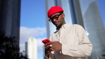 Stylish african american man using smartphone in downtown city