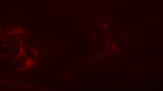 Red storm clouds rolling and moving in dark sky. Dramatic background for horror, sci-fi, or mars-themed videos. Time lapse