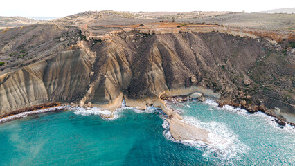 Coastal landscape of Malta, featuring a majestic cliffside, turquoise sea, and dramatic rock formations.