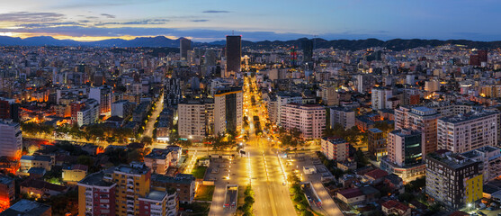 Fototapeta premium Dawn aerial of Tirana with Zogu I Boulevard leading into the city skyline.