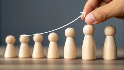 Hand placing wooden pawn figure to show upward trend in business growth concept