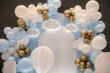 Decor clouds and hot air balloons. Celebration baptism concept. Birthday decor for a baby boy party...
