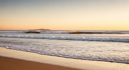 Obraz premium Golden Hour at the Coastline: Serene Beach Scenery with Gentle Waves and Warm Light